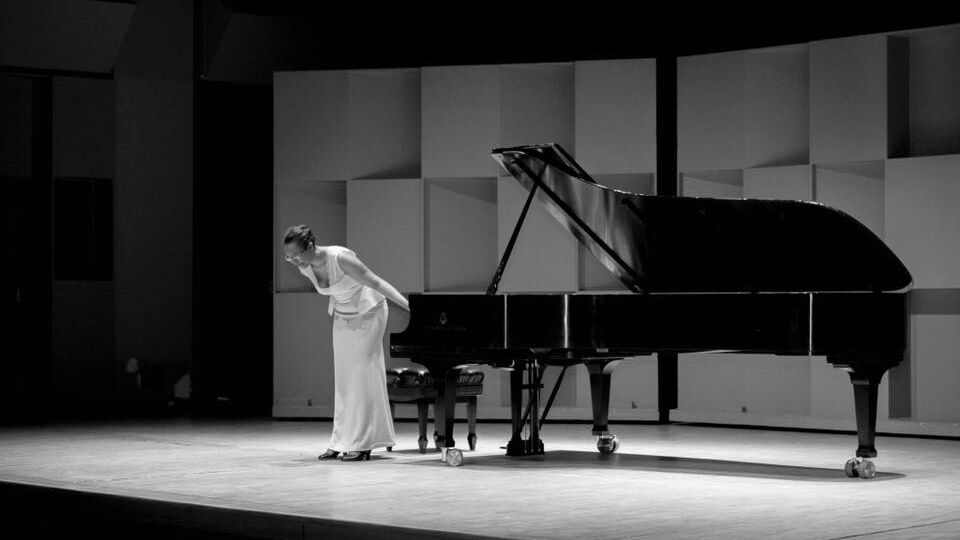 Woman with her piano on stage