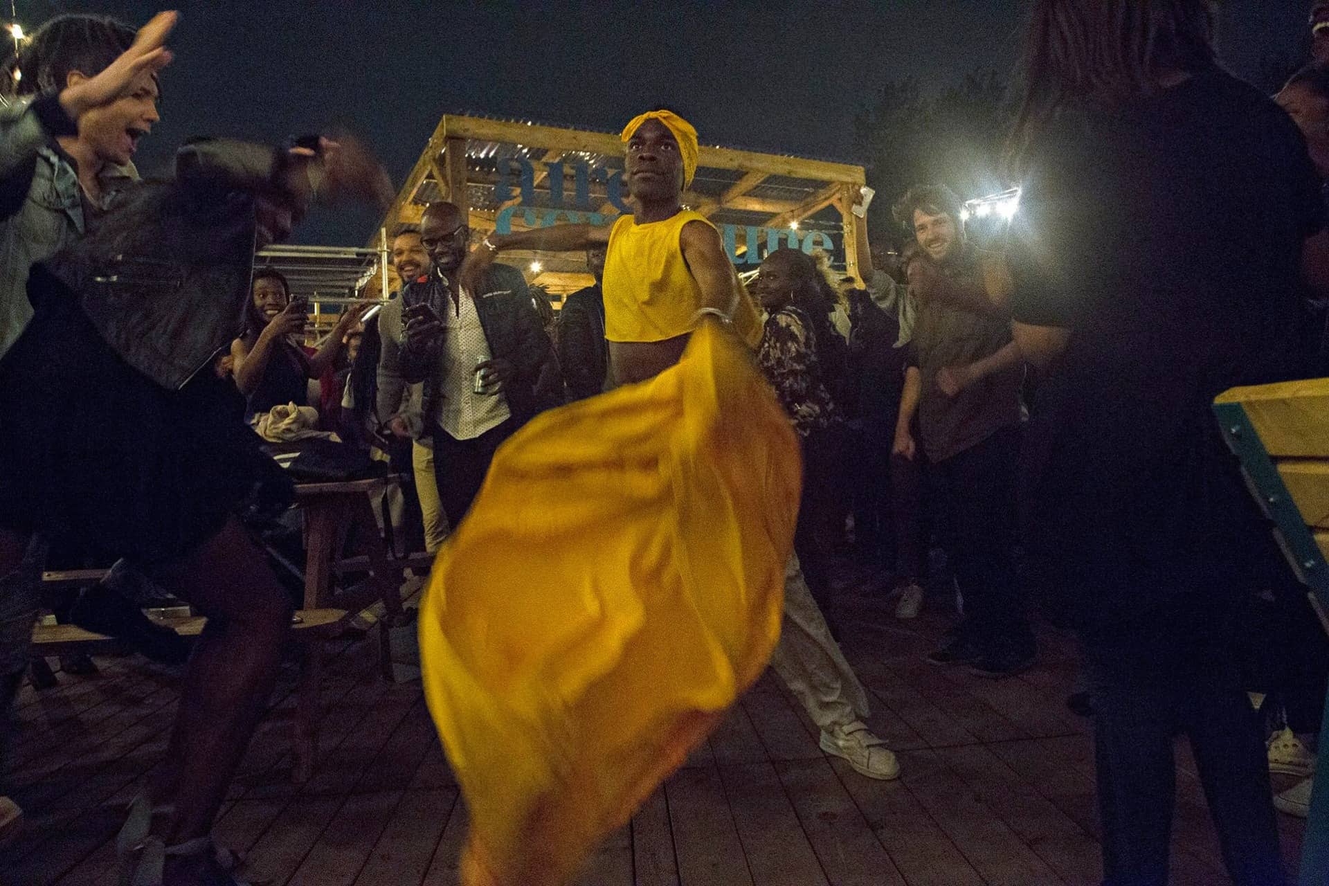 Elegant person in yellow clothes dancing at Cultures event